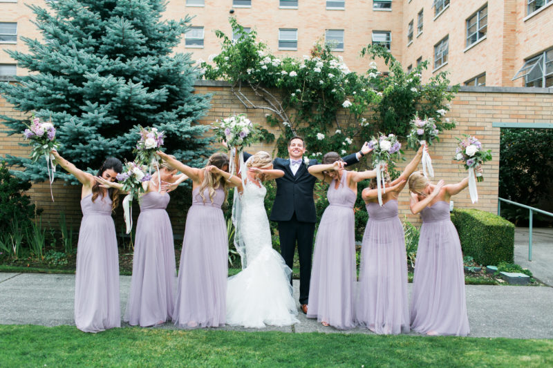 Groom and Bride with Bridesmaids dabbing after Wedding Ceremony