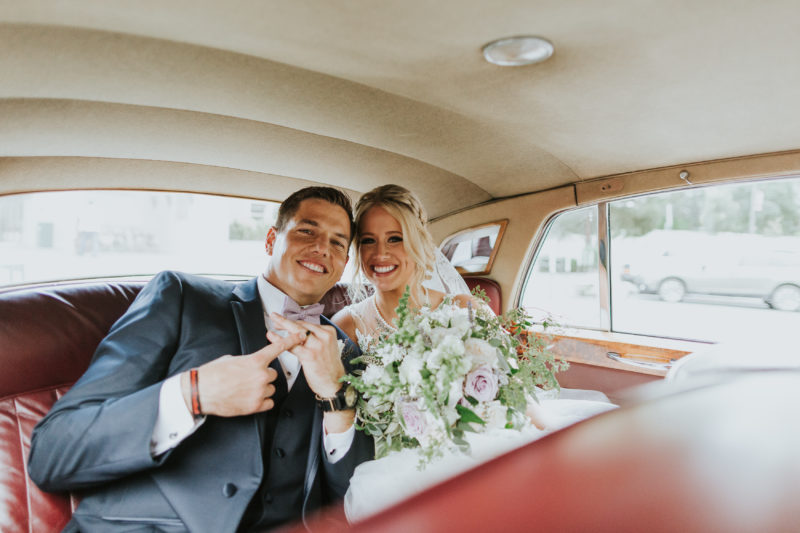 Groom shows off his wedding ring in getaway car after Ceremony