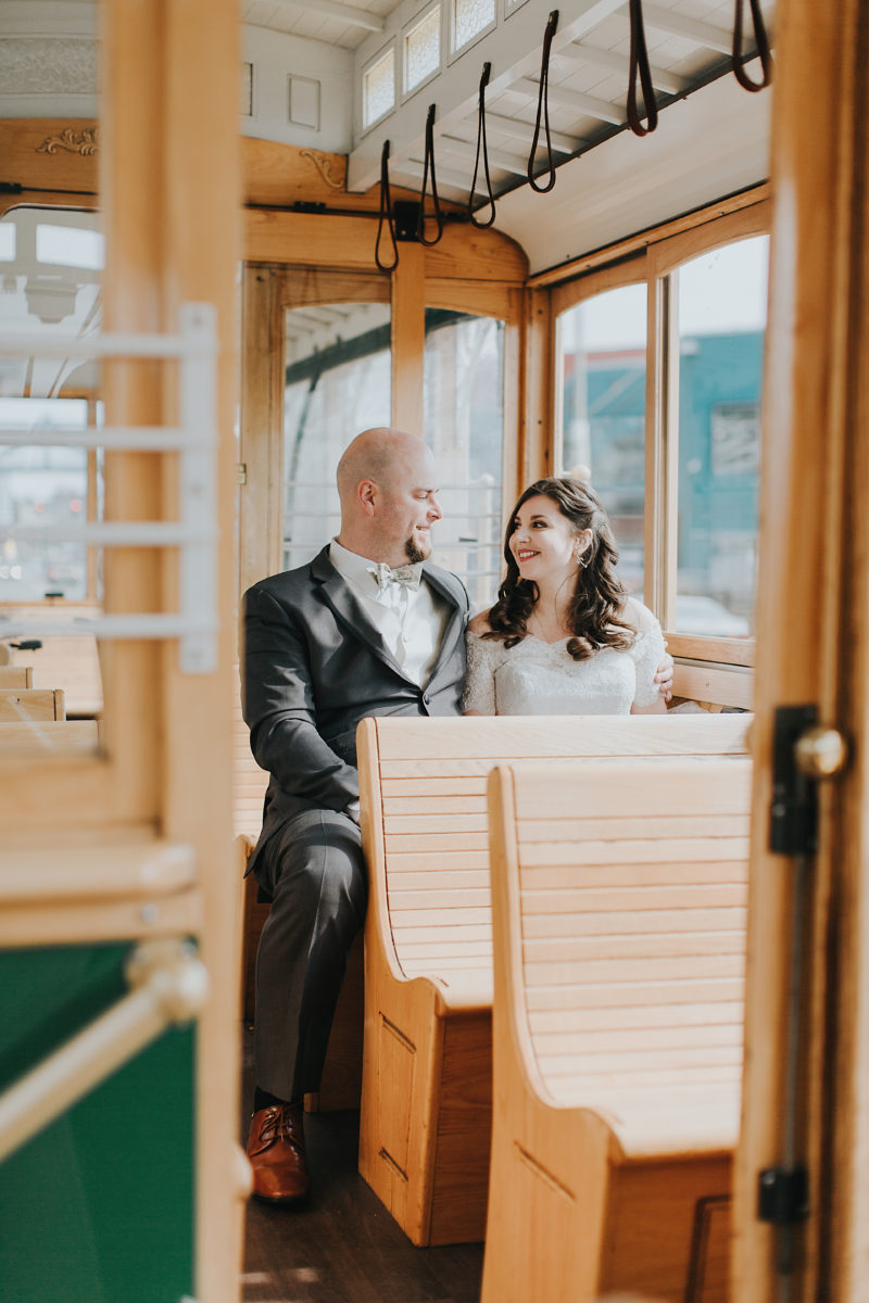 Bride and Groom on empty Emerald City Trolly in downtown Seattle