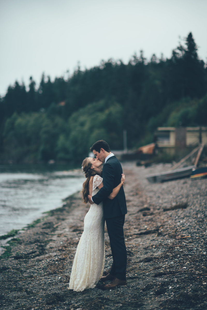 Bride and Groom kissing on beach before Ceremony
