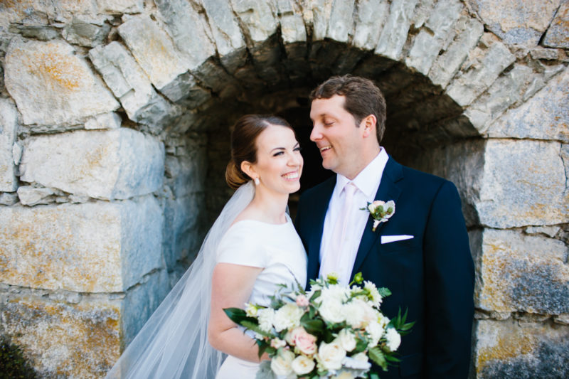 Bride and Groom laughing in front of Roche Harbor lime kilns