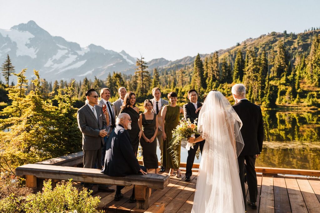 Bride & groom do a first look with their wedding party at Picture Lake near Mount Baker!